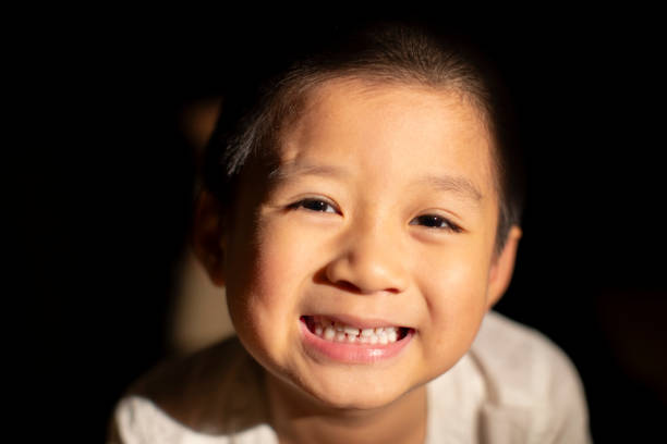 A cute and handsome Asian boy smiled happily at the camera
