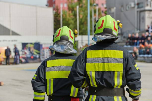 A team of confident and accomplished firefighters strides purposefully in their uniforms, exuding pride and satisfaction after successfully completing a challenging firefighting mission