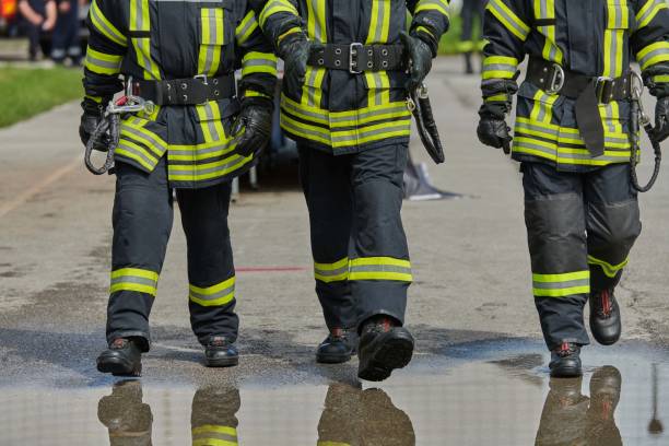 istock A team of confident and accomplished firefighters strides purposefully in their uniforms, exuding pride and satisfaction after successfully completing a challenging firefighting mission 2156340766