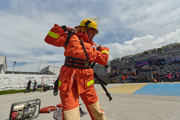 istock In a dynamic display of synchronized teamwork, firefighters hustle to carry, connect, and deploy firefighting hoses with precision, showcasing their intensive training and readiness for challenging and high-risk situations ahead 2156343626