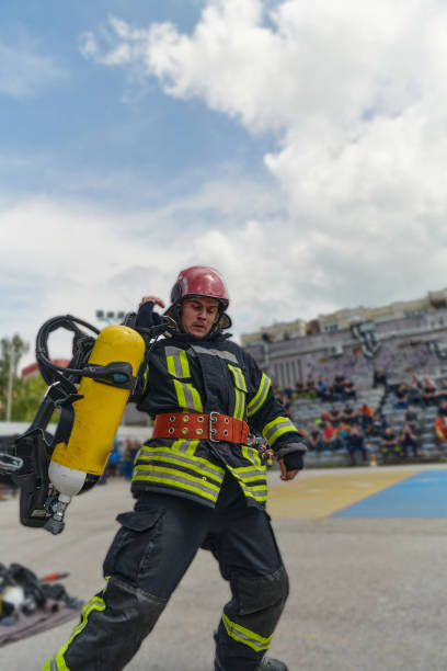 istock A firefighter dons the essential components of their professional gear, embodying resilience, commitment, and readiness as they gear up for a hazardous firefighting mission, a testament to their unwavering dedication to protecting and saving lives 2156343683