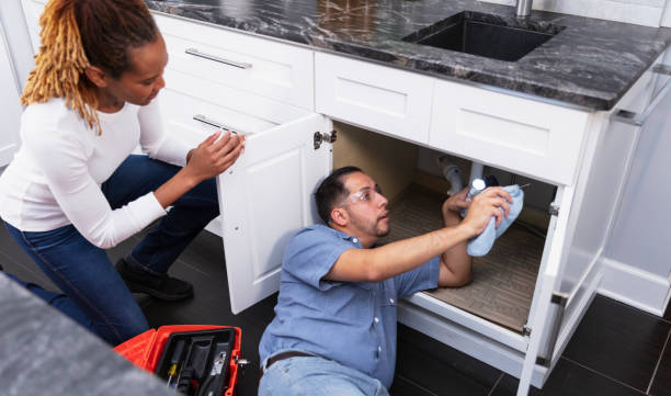 istock Handyman or plumber looking under kitchen sink 2156345325