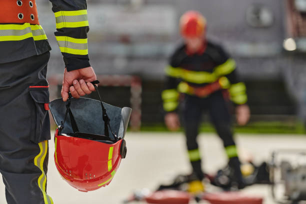 istock Close up of Firefighter's Hand Holding Fire Helmet 2156347981