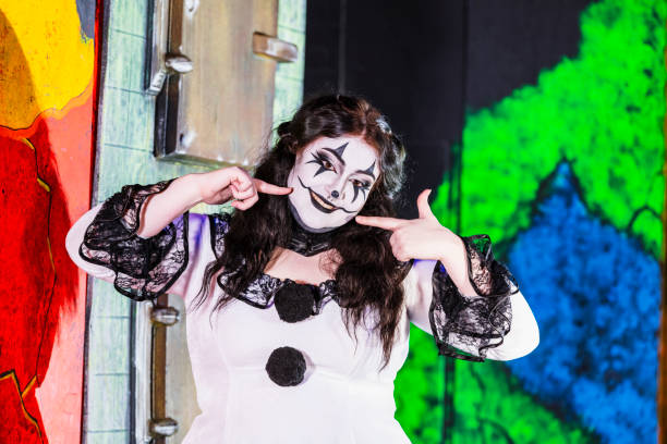 Halloween Haunted House. A young woman dressed as a creepy clown.