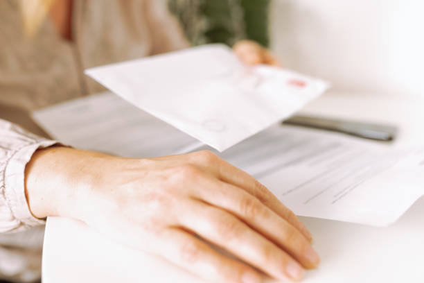 istock woman's hands holding an envelope with a letter 2156349677