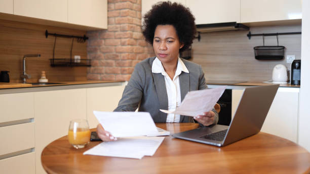 istock Woman calculating her monthly costs 2156349947