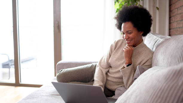 istock Happy woman working on the sofa 2156350707
