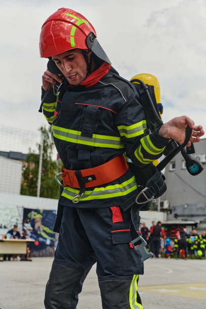 istock Professional Firefighter Suits Up in Full Gear for Duty 2156350788