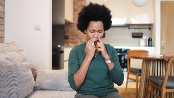 istock Woman using spray for her allergy 2156351211
