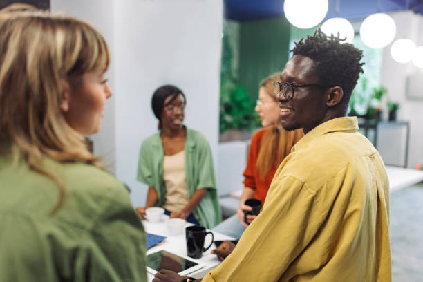 istock Colleagues talking in office break room 2156351239