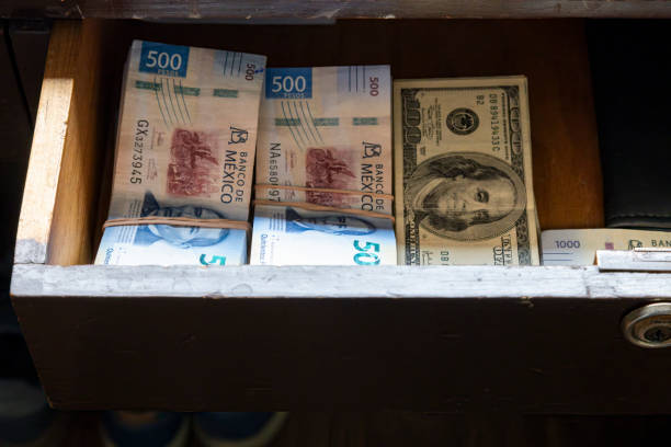 Mexican pesos and dollars in a drawer