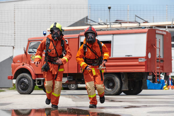 A team of confident and accomplished firefighters strides purposefully in their uniforms, exuding pride and satisfaction after successfully completing a challenging firefighting mission