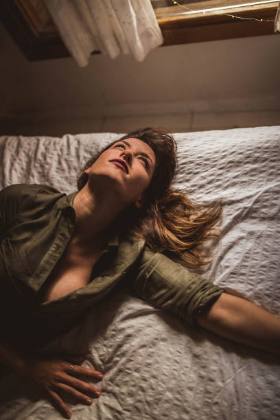 istock Pretty woman lying on bed and looking up 2156353633