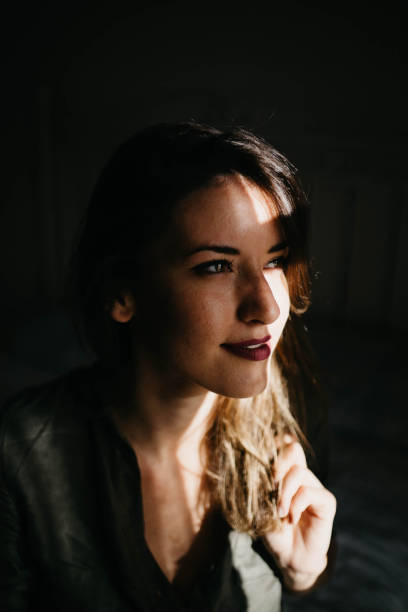 istock Beautiful woman in dark room 2156353646