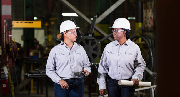 istock Two multiracial women engineers walking in warehouse 2156353765