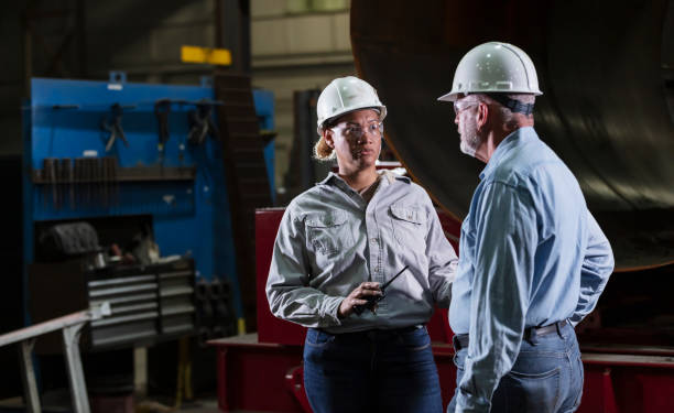 Multiracial woman, senior man working in warehouse