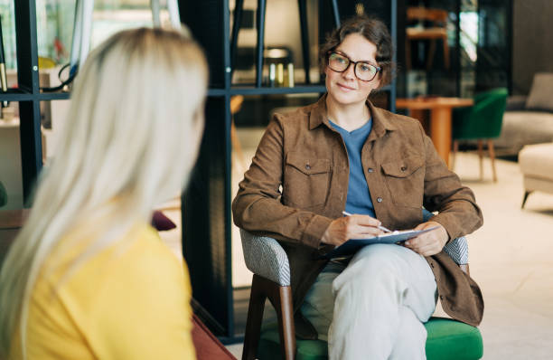 istock A professional female psychological consultant listens to a client while sitting at her workplace. 2156354511