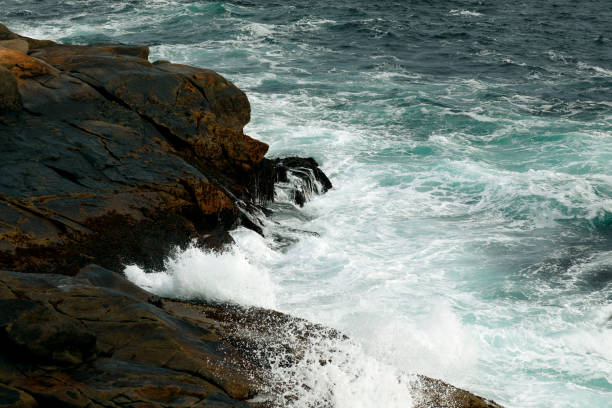 A beautiful view of ocean waves crashing into the shore of Peggy's Cove, Nova Scotia, Canada. Shot with a Canon 5D Mark IV.