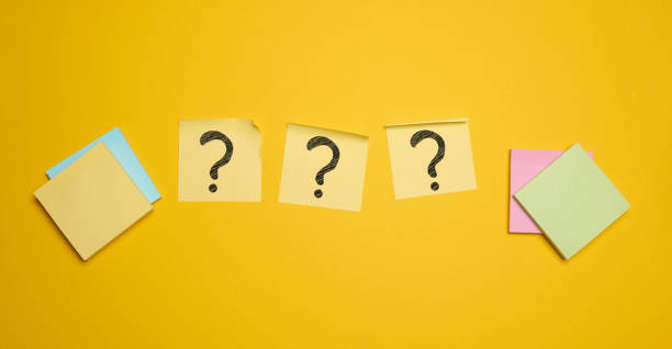 istock Drawn question marks on stickers, yellow background. Searching for truth 2156360110