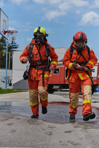 istock A team of confident and accomplished firefighters strides purposefully in their uniforms, exuding pride and satisfaction after successfully completing a challenging firefighting mission 2156360994