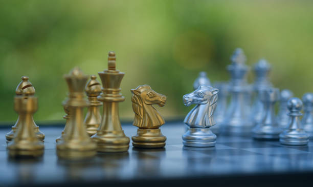 istock gold  knight Against whithe background, International chess, ideas and competition and strategy, chess board game competition business concept. 2156361273