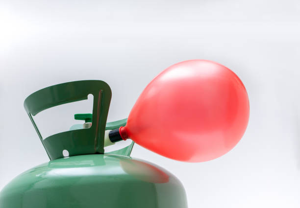 istock Helium gas cylinder and balloon isolated 2156361321