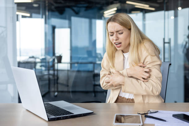 istock Stressed businesswoman experiencing pain while working in modern office environment 2156361666