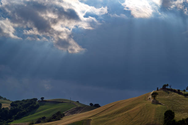 view of the field on the hill under a stormy sky