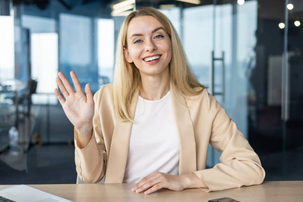 istock Professional woman in an office greeting with a smile 2156363670