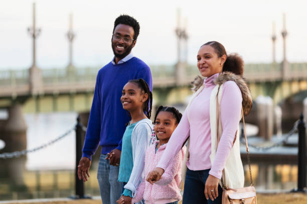istock Multiracial family with two girls walking on waterfront 2156363676
