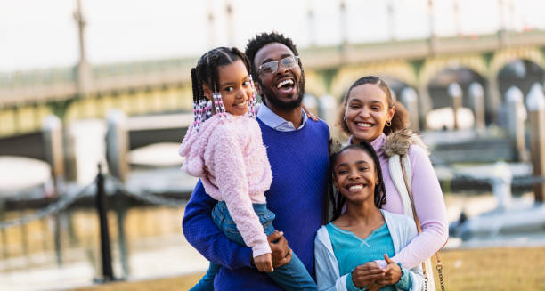 istock Multiracial family  on waterfront smiling at camera 2156363703