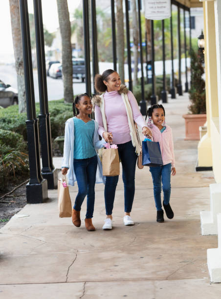 istock Mother, daughters shopping in city 2156363804