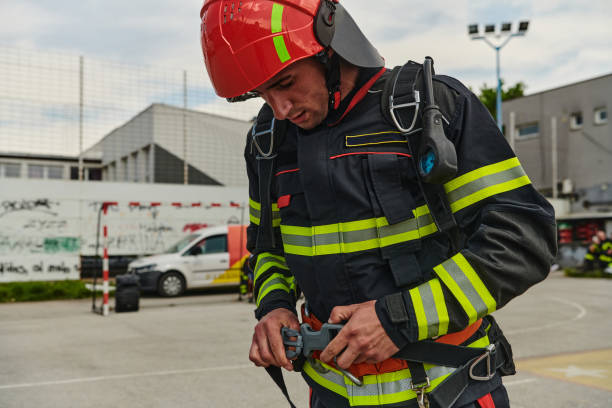 istock Professional Firefighter Suits Up in Full Gear for Duty 2156363957