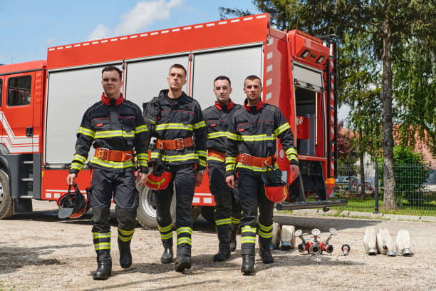 istock Team of Professional Firefighters Ready in Full Gear for Dangerous Situations 2156365368