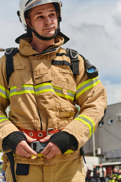 istock A firefighter dons the essential components of their professional gear, embodying resilience, commitment, and readiness as they gear up for a hazardous firefighting mission, a testament to their unwavering dedication to protecting and saving lives 2156365466