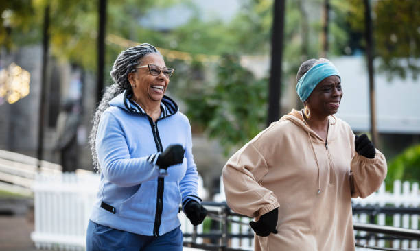 istock Two black senior women exercising, power walking in park 2156366557