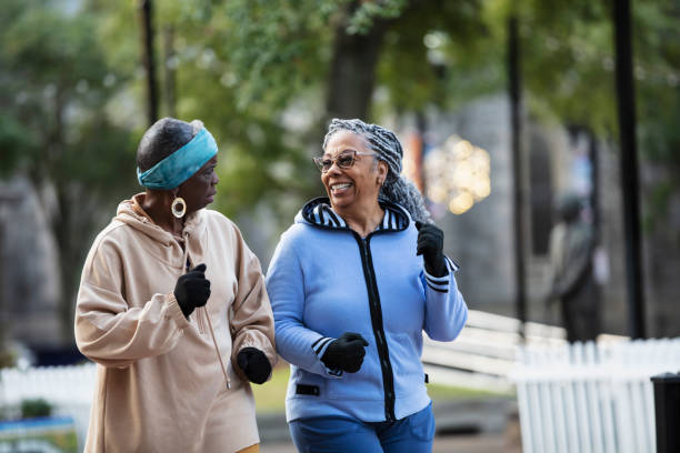 istock Two black senior women exercising, power walking in park 2156366569