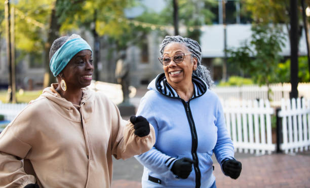 istock Two black senior women exercising, power walking in park 2156366571