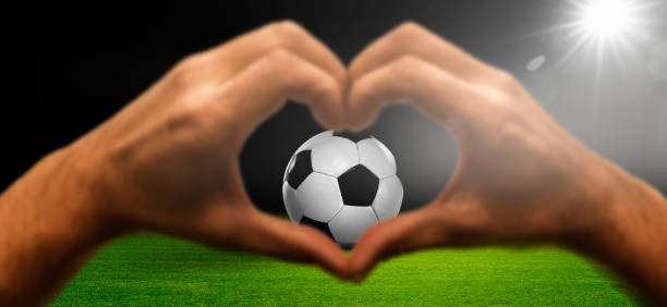 istock Heart hand with soccer ball in the stadium 2156367032