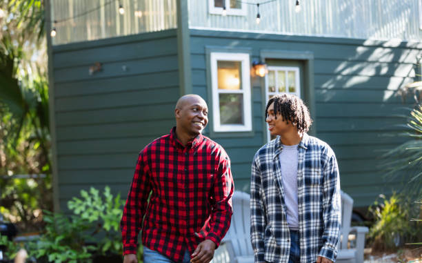 istock Father and teenage son conversing in back yard 2156367953