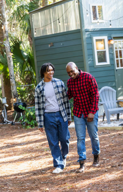 istock Father and teenage son conversing in back yard 2156367963