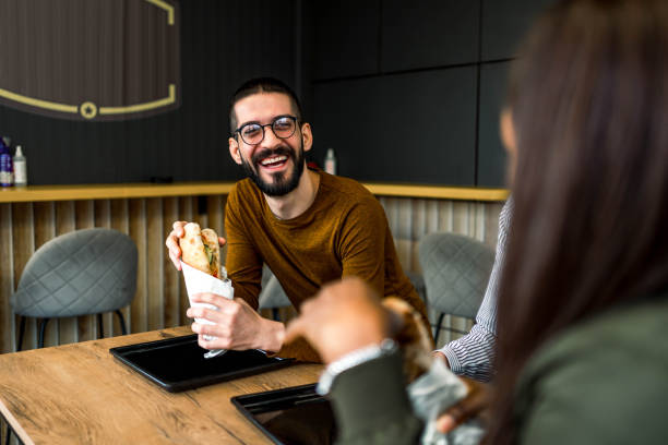 istock Friends eating in fast food restaurant 2156368883