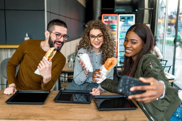 istock Friends taking selfies in fast food restaurant 2156369017