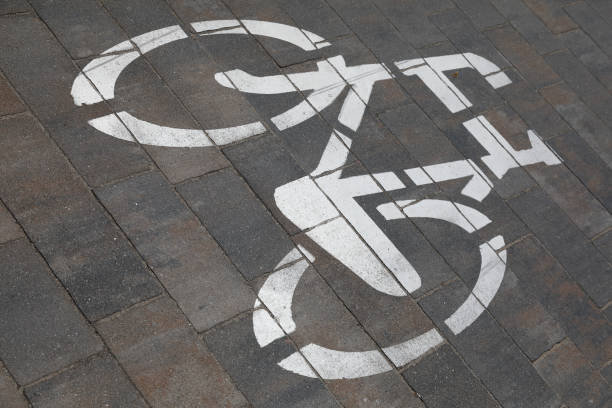 istock The silhouette of a bicycle on the road indicates that the cycle path is here 2156369242