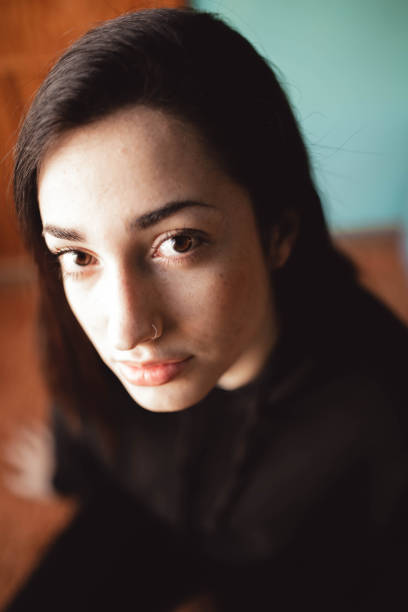 istock young woman looking straight ahead with serious attitude 2156369447