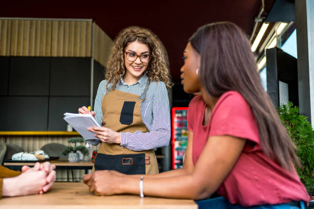 istock Waitress is taking customers' orders in a fast food restaurant 2156369547