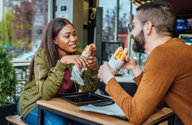 istock Couple eating in fast food restaurant 2156369588