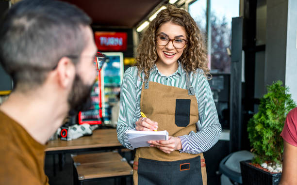 istock Waitress is taking customers' orders in a fast food restaurant 2156369738