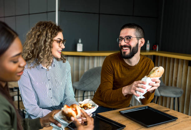 istock Friends eating in fast food restaurant 2156369821