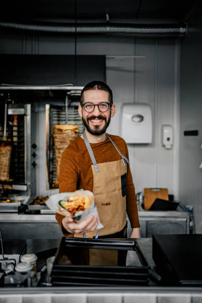 istock Male worker in a fast food shop 2156369965